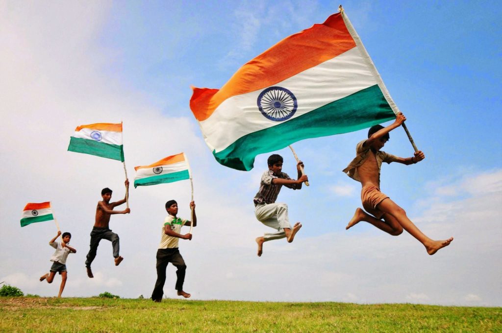 five children holding indian flag and cheering